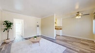 Located at 526 E Windsor Rd in Glendale, CA, this single-floor, one-bedroom, one-bathroom unit offers a well-organized and efficient layout. Throughout the space, light gray hardwood-style flooring provides a cohesive and modern aesthetic, complemented by warm beige walls and crisp white trim.

The living area is generously proportioned, featuring elegant crown molding, natural light from large windows, and an open feel that makes the space appear larger than its footprint suggests. A hallway connects the main living area to the remaining rooms, creating a practical flow throughout.

The kitchen is equipped with white cabinetry, a stainless steel sink, warm wood-toned countertops, a range with overhead ventilation hood, and a skylight that brightens the workspace. Crown molding continues into the kitchen, maintaining a consistent design language.

The bedroom is a comfortable, sunlit retreat with a ceiling fan and light fixture, a large window dressed with vertical blinds, and a closet. Natural light pours in, casting warmth across the flooring.

The bathroom is clean and functional, featuring a white vanity with under-cabinet storage, a wall-mounted mirror, and a full tub and shower combination enclosed by sliding glass doors. The same hardwood-style flooring extends here, tying the space together seamlessly.