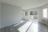 Located at 6321 Monterey Rd in the vibrant Highland Park neighborhood of Los Angeles, this single-floor unit offers a thoughtfully updated living space with a clean, contemporary aesthetic throughout. Light-toned luxury vinyl plank flooring runs seamlessly across the entire unit, creating a cohesive and modern foundation in every room. The kitchen is a standout feature, boasting white shaker cabinets, sleek quartz-style countertops, stainless steel appliances including a gas range and refrigerator, a deep double-basin sink, and a striking mosaic tile backsplash in cool blue and gray tones that adds visual interest. Two bathrooms serve the unit — one features large-format neutral tile surrounding the tub-shower combo, a quartz vanity top, brushed gold fixtures, and a well-lit vanity mirror, while the second offers a classic tiled tub-shower with a curtain rod setup. The bedrooms are bathed in natural light through generously sized windows fitted with blinds, offering pleasant views of the surrounding tree-lined neighborhood. A dedicated entryway with cool gray walls and clean white trim provides a welcoming transition into the living space. The overall ambiance is bright, clean, and move-in ready, with modern updates throughout.