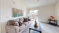 Located at 1911 Saddlebrook Dr in Murfreesboro, Tennessee, this single-story home offers a thoughtfully designed layout with comfortable living spaces throughout. The living room is a welcoming centerpiece, featuring vaulted ceilings that lend an open, airy feel, soft carpeting, and a sliding glass door that opens to a private balcony with outdoor views — ideal for relaxing or entertaining. The kitchen is outfitted with warm honey-toned wood cabinetry, ample counter space, a double basin sink, and stainless steel appliances including a dishwasher and electric range, all set atop wood-look flooring. The bedrooms are well-proportioned, each featuring plush carpeting, ceiling fans with light fixtures, and windows that invite natural light. At least one bedroom includes a spacious walk-in closet with wire shelving for generous storage. The bathroom features wood-look flooring, a full vanity with an extended mirror, and a tub-shower combination. Throughout the home, neutral wall tones and consistent finishes create a cohesive and livable atmosphere, making this Murfreesboro property a practical and comfortable place to call home.