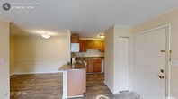 Located at 5011 S Alston Ave in Durham, NC, this one-bedroom, one-bathroom residence offers a well-organized single-floor layout designed for comfortable everyday living. The open-concept living room and kitchen area anchors the home, featuring durable hardwood-style plank flooring, warm neutral wall tones, and a ceiling fan with light fixture overhead. A textured ceiling adds classic character throughout the main living space. Sliding glass doors flood the living room with natural light and provide direct access to an outdoor patio, offering pleasant views of the surrounding greenery.

The kitchen is well-appointed with rich, raised-panel oak cabinetry offering generous storage, dark granite-style laminate countertops, and a full suite of white appliances including a range, over-the-range microwave, dishwasher, and refrigerator. Hardwood-style flooring continues seamlessly through the kitchen, creating a cohesive flow.

The bedroom is a comfortable retreat, carpeted for warmth and featuring a closet, a mirrored accent panel, and a window with outdoor views and natural light. The full bathroom includes a combined tub and shower with chrome fixtures, maintaining a clean and functional aesthetic throughout.