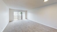 Located at 10409 SE 174th St in Renton, WA, this single-floor, one-bedroom, one-bathroom unit offers a practical and comfortable layout across a well-utilized floor plan. The inviting living room is the heart of the home, featuring plush wall-to-wall carpeting, a textured ceiling, and a large sliding glass door with vertical blinds that fills the space with natural light and provides outdoor access. Adjacent to the living area, the galley-style kitchen is outfitted with warm wood cabinetry, white countertops, a full suite of white appliances including a refrigerator, range, and dishwasher, and durable hardwood-style flooring. A ceiling light fixture brightens the kitchen, which connects seamlessly to the hallway. The bedroom is a comfortable size, with soft carpeting, neutral walls, and a window overlooking the exterior. It is complemented by a generously sized walk-in closet featuring built-in shelving and hanging rods for ample storage. The bathroom includes a full soaking tub with a shower, a curved curtain rod, and hardwood-style flooring. Additional highlights include two hallways, a dedicated utility room, and a second closet for extra storage throughout the unit.