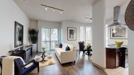 Located at 3616 Richmond Ave in Houston, TX, this well-appointed two-bedroom, two-bathroom residence is designed for comfortable urban living. The open-concept living and dining area is anchored by rich dark hardwood flooring and bathed in natural light from large windows and a sliding glass door that opens to a private balcony with outdoor views. Track lighting illuminates the living space, while a dedicated dining nook features a bay-style window arrangement, enhancing the airy feel.

The kitchen is a standout, outfitted with rich dark wood cabinetry, dark granite countertops, a tiled backsplash, stainless steel appliances including a French door refrigerator, and a breakfast bar island — all complemented by tile flooring.

The primary bedroom offers plush carpeting, soaring ceilings, natural light from a large sliding door to a second balcony, and a dedicated closet. The second bedroom is equally well-sized with similar finishes. Both bathrooms are finished with tile flooring, dark wood vanity cabinetry, granite countertops, and tub-shower combinations with tile surrounds.

A hallway connects the spaces and conveniently houses an in-unit washer and dryer. Two closets provide ample storage throughout this thoughtfully designed single-floor home.