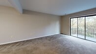 Located at 802 Carriage Rd in Pittsburgh, PA, this multi-floor residence spans three levels and offers a functional, well-organized layout throughout. The living areas feature neutral-toned carpeting and large windows that draw in natural light and frame views of the surrounding tree-lined exterior. Several rooms open to a balcony, extending the living space outdoors and providing pleasant wooded views.

The bedrooms are generously sized, finished with soft carpeting and painted in calming neutral tones. Closet space is incorporated into the bedroom design, with sliding doors and built-in shelving for organized storage. Windows throughout the bedrooms allow for ample natural light and outdoor views.

The kitchen is equipped with a range and features a large window fitted with horizontal blinds, offering views of the surrounding landscape. The light-toned tile flooring gives the space a clean, practical finish.

Multiple bathrooms serve the home, each featuring tile flooring, vanities with wood cabinetry, white countertops, and large mirrors. One bathroom includes a full tub-shower combination with white tile surround, while a separate water closet provides added convenience and privacy. The consistent neutral palette throughout the home creates a cohesive and comfortable living environment.