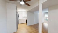Located at Saratoga Ave in San Jose, CA, this single-floor, two-bedroom, one-bathroom residence offers a practical and comfortable layout across a well-utilized footprint. Hardwood flooring runs throughout the home, lending warmth and visual continuity to every room.

The living room is a generous, light-filled space anchored by a large sliding glass door that opens to an outdoor patio, inviting natural light and providing easy access to the exterior. The kitchen has been thoughtfully updated with white cabinetry, marble-style tile backsplash, light countertops, and stainless steel appliances including a French door refrigerator and dishwasher. A cozy dining nook sits just adjacent, ideal for everyday meals.

The primary bedroom is notably spacious, offering ample room for multiple furniture pieces and featuring wood flooring and neutral walls. The second bedroom also provides comfortable accommodations. Both bedrooms are supported by a total of three closets distributed throughout the home, offering solid storage capacity. A dedicated utility room adds further practicality.

The bathroom is clean and bright, finished with light wood flooring, a wide vanity with under-cabinet storage, and a tall linen cabinet. A hallway connects the rooms efficiently, completing this well-organized and functional San Jose residence.