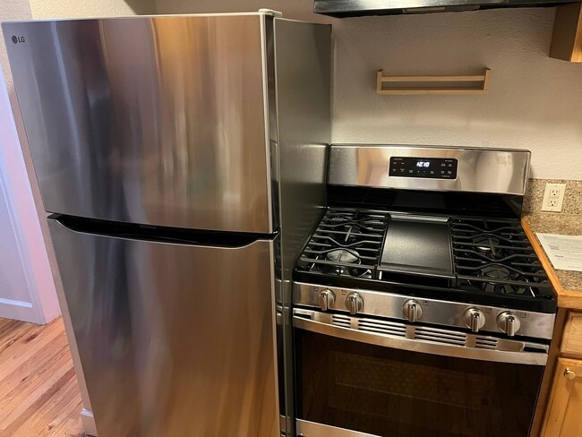 Kitchen with new stainless steel stove, dishwasher and refrigerator - 1629 N Clarkson St (Denver, CO) Apartment