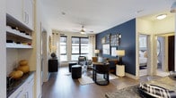 Located at 1900 Chapman Ave in Rockville, MD, this thoughtfully designed single-floor residence combines contemporary style with functional living. The living room serves as the centerpiece of the home, featuring rich hardwood flooring, a ceiling fan, and large windows that flood the space with natural light and offer views of the surrounding cityscape. A bold navy accent wall paired with curated gallery art creates a sophisticated, upscale ambiance.

The kitchen is a standout space, outfitted with crisp white shaker cabinetry, granite countertops, a classic subway tile backsplash, and stainless steel appliances. A large island with seating provides both prep space and a casual dining area, illuminated by stylish pendant lighting.

The bedrooms offer a calm retreat, each featuring plush carpeting, ceiling fans, and large windows. Accent walls in deep navy and warm gold tones add character, while generous closet space ensures ample storage.

The bathrooms are well-appointed with dark wood vanities, stone-topped counters, and soaking tub and shower combinations. Each bathroom connects directly to a walk-in closet, enhancing the sense of thoughtful layout and everyday convenience throughout this polished, move-in-ready home.