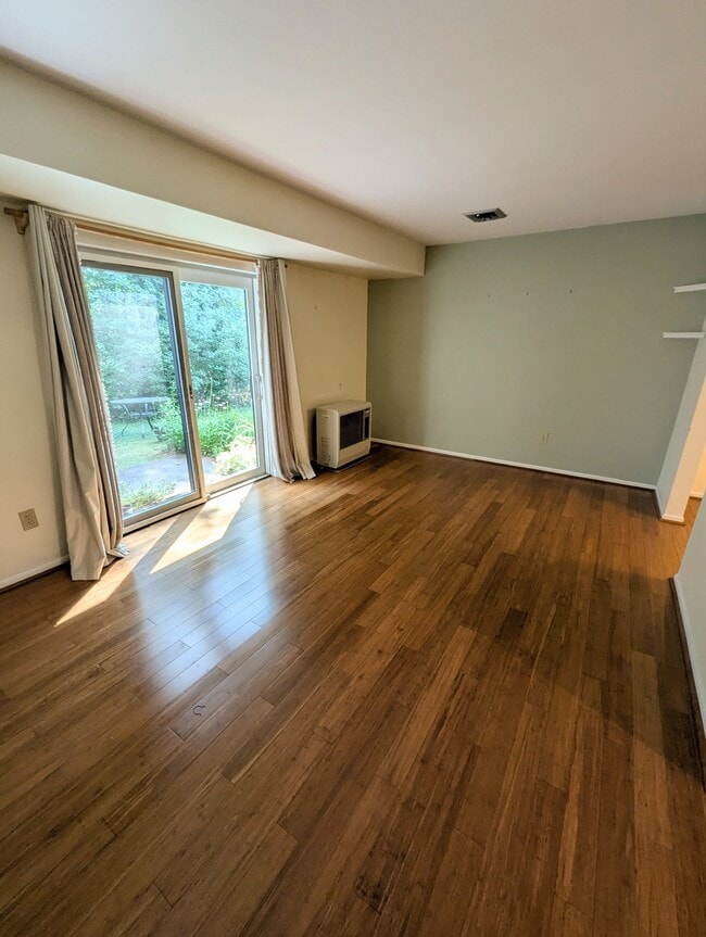Living room features slider door overlooking private back patio with garden - 4 Chelsea Cir