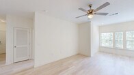 This well-appointed single-story home in Augusta, Georgia offers three bedrooms, two bathrooms, and a thoughtfully designed layout that balances comfort and functionality. Light hardwood flooring flows through the main living areas, complemented by crisp white walls and an abundance of natural light from well-placed windows. The kitchen is a standout feature, showcasing rich dark wood cabinetry, marble-style countertops, a central island with pendant lighting, and black appliances including a range and built-in microwave. A dedicated laundry area with washer and dryer hookups is conveniently accessible from the kitchen. The primary bedroom is generously sized, featuring plush carpeting, a ceiling fan, and a large window overlooking lush greenery. The additional bedrooms also offer comfortable carpeted flooring and ceiling fans. The bathrooms are finished with marble-style countertops, dark wood vanities, large mirrors, and natural light from windows. Three closets provide ample storage throughout the home. The overall ambiance is clean, bright, and move-in ready, making this Augusta residence a practical and attractive living space.