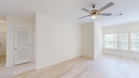 This well-appointed single-story home in Augusta, Georgia offers three bedrooms, two bathrooms, and a thoughtfully designed layout that balances comfort and functionality. Light hardwood flooring flows through the main living areas, complemented by crisp white walls and an abundance of natural light from well-placed windows. The kitchen is a standout feature, showcasing rich dark wood cabinetry, marble-style countertops, a central island with pendant lighting, and black appliances including a range and built-in microwave. A dedicated laundry area with washer and dryer hookups is conveniently accessible from the kitchen. The primary bedroom is generously sized, featuring plush carpeting, a ceiling fan, and a large window overlooking lush greenery. The additional bedrooms also offer comfortable carpeted flooring and ceiling fans. The bathrooms are finished with marble-style countertops, dark wood vanities, large mirrors, and natural light from windows. Three closets provide ample storage throughout the home. The overall ambiance is clean, bright, and move-in ready, making this Augusta residence a practical and attractive living space.