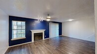 This 680 square foot apartment in Dallas, TX offers a thoughtful blend of comfort and functionality. The single-floor layout maximizes space efficiency, featuring one bedroom and two full bathrooms. The heart of the home is an open-concept living area, seamlessly integrating the kitchen and living room for a spacious feel.

The primary bedroom, measuring 150 square feet, provides ample space for rest and relaxation. Two closets offer generous storage solutions throughout the apartment. The bathrooms showcase modern design with clean lines, featuring updated fixtures, round mirrors, and sleek vanities.

The kitchen boasts contemporary cabinetry and marble-like countertops, creating a stylish and practical cooking space. Throughout the apartment, wood-look flooring adds warmth and durability. Large windows in the living area and bedroom allow natural light to flood the space, while blinds provide privacy control.

A standout feature is the cozy fireplace with a white mantle, set against a striking navy accent wall in the living room. This creates a focal point and adds character to the space. Recessed lighting and modern ceiling fixtures ensure well-lit interiors.

Overall, this apartment combines efficient design with modern aesthetics, offering a comfortable living space in a prime Dallas location.