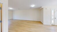 Located at 770 E Ashland St in Brockton, MA, this well-appointed 2-bedroom, 2-bathroom residence offers a thoughtfully designed single-floor layout with a clean, modern aesthetic throughout. Light-toned hardwood-style flooring runs continuously across all rooms, creating a cohesive and bright atmosphere.

The kitchen is a standout feature, showcasing slate-gray shaker cabinetry, a subway tile backsplash, and a generous granite-topped island with pendant lighting overhead. Recessed lighting and large windows flood the space with natural light, while a full suite of appliances completes the functional layout. The kitchen opens directly to the living area, reinforcing the open-concept feel.

The living room is spacious and airy, featuring sliding glass doors that lead to a private outdoor balcony with wooded views — an ideal retreat for relaxing or entertaining.

Both bedrooms are comfortably sized with large windows that invite natural light; the primary bedroom includes a sliding-door closet for ample storage. The two bathrooms are finished with granite-topped dark vanities and light tile flooring. One bathroom features a walk-in corner glass shower, while the other offers a full soaking tub and shower combination. The overall palette — neutral walls, light floors, and modern fixtures — gives the entire residence a fresh, move-in-ready feel.
