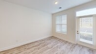 This contemporary single-story residence offers a blend of comfort and functionality across its 2,460 square feet. The heart of the home is a sleek, open-concept kitchen featuring stainless steel appliances, white cabinetry, and a large island with granite countertops. Pendant lighting adds a touch of elegance, while the adjacent living area provides ample space for relaxation and entertainment.

The home boasts three bedrooms, including an impressively spacious primary bedroom measuring 1,710 square feet. All bedrooms feature plush carpeting and large windows with blinds, allowing for abundant natural light. The bathroom is modern and efficiently designed, with a clean white palette and wood-look flooring.

Throughout the home, you'll find a cohesive design aesthetic with neutral walls, recessed lighting, and a mix of carpeted and wood-look flooring. The dedicated laundry room comes equipped with full-sized washer and dryer units, ensuring convenience for daily tasks.

Large windows in various rooms offer views of the surroundings and flood the space with natural light. The property also includes outdoor parking facilities, adding to its practicality. With its generous proportions and contemporary finishes, this home presents an ideal living space for those seeking both comfort and style.