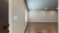 Located at 560 West Bryant Street in Springfield, Missouri, this two-story home offers a well-designed layout across two levels. The kitchen is a standout feature, showcasing shaker-style cabinetry in a warm gray-white finish, light quartz countertops, a classic white subway tile backsplash, a central island, stainless steel appliances including a refrigerator, range, microwave, and dishwasher, and rich hardwood-style vinyl plank flooring. A half bath on the main level features a pedestal sink, mirror, and matching dark hardware accents, with wainscoting detail on the door. The laundry room includes wire shelving and a window for natural light. Upstairs, carpeted bedrooms provide a comfortable feel, each with windows dressed in blinds and ceiling fans for added comfort. One bedroom features sliding glass doors that invite natural light and outdoor access. The full bathroom upstairs is well-appointed with a dual-sink vanity, ample cabinetry, and hardwood-style flooring. A spacious walk-in closet with wire shelving systems offers generous storage. A railed staircase connects the two floors, visible in the architectural overview, reinforcing the home's open and functional two-story design throughout.