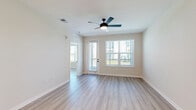 Located at 4741 Hoffner Ave in Orlando, FL, this well-appointed single-story home offers three bedrooms, three bathrooms, and three closets within a thoughtfully designed floor plan. Light wood-look flooring runs throughout, creating a clean, cohesive aesthetic across every room.

The open-concept kitchen and living area serves as the heart of the home. The kitchen is outfitted with flat-front natural wood cabinetry, white quartz countertops, a white subway tile backsplash, a deep single-basin sink with a matte black faucet, and a full suite of stainless steel appliances. A central island provides additional prep and dining space, while recessed lighting keeps the area bright and welcoming.

The bedrooms are bright and airy, with neutral walls, ceiling fans, and windows dressed with horizontal blinds that invite natural light. The generously sized primary bedroom includes its own dedicated closet with built-in wire shelving. Each of the three closets features wire shelving systems that maximize storage efficiency.

The bathrooms are elegantly finished with marble-look tile, extending floor to ceiling in the shower and tub surrounds. One bathroom features a glass-enclosed walk-in shower with matte black fixtures, while another offers a soaking tub. The overall design is modern, clean, and move-in ready.