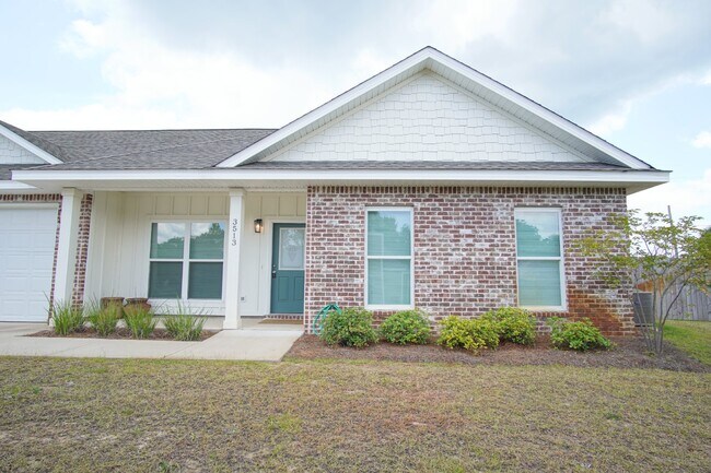 Building Photo - 3 bed 2 bath brick townhome with a 2 car g...