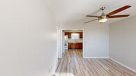 Located at 42 Heppner Ln in Ringgold, Georgia, this single-floor, one-bedroom, one-bathroom home offers a practical and well-organized layout. Light wood-style flooring flows consistently throughout the space, creating a cohesive and clean aesthetic.

The living room serves as the main gathering area, featuring a ceiling fan with light fixture and a textured ceiling. Natural light enters through a window, lending a bright and airy feel to the room. The entry door is conveniently positioned nearby.

The kitchen is well-equipped with rich warm-toned wood cabinetry spanning both upper and lower sections, a double-basin sink beneath a window that admits natural light, white appliances including a range, refrigerator, and overhead ventilation hood, and a flush-mount ceiling light for functional illumination.

The bedroom offers a comfortable footprint with its own ceiling fan, a window with blinds, and direct access to the bathroom. The bathroom includes a single-basin vanity with a wide mirror, wood cabinetry below, and a tub-shower combination.

Additional spaces include a dedicated utility room and a closet, contributing to overall storage and functionality. The home's consistent flooring, neutral color palette, and practical room arrangement make it a straightforward and efficient living space.