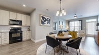 Located at 11240 Woolwich St in Charlotte, NC, this single-floor, 2-bedroom, 2-bathroom residence offers a thoughtfully designed open-concept layout that seamlessly connects the kitchen, dining, and living areas. Wood-style flooring flows throughout the main living spaces, anchored by a dedicated entrance and a cohesive neutral color palette.

The kitchen features light wood cabinetry, granite countertops, a white subway tile backsplash, and black Whirlpool appliances, including a range and over-the-range microwave. The adjoining dining area is illuminated by a modern pendant chandelier, while the living room benefits from large windows that invite abundant natural light and a ceiling fan overhead.

Both bedrooms are carpeted and generously proportioned, with the primary bedroom offering ample space for a full suite of furniture. Each bedroom is served by a closet for organized storage. The bathrooms include wood-style flooring, white vanity cabinetry with white countertops, and a tiled tub-shower combination. A dedicated laundry room houses a full-size Whirlpool washer and dryer. The layout also includes two closets for additional storage, rounding out a functional and comfortable living space.