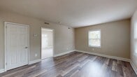 This 500 square foot apartment, located in the Presidential Greens complex, offers a thoughtful blend of comfort and functionality. The space comprises two bedrooms, one bathroom, a kitchen, and a hallway, all arranged on a single floor. The primary bedroom is notably spacious at 220 square feet, providing ample room for relaxation and storage.

Throughout the apartment, neutral-toned walls create a bright, airy atmosphere, complemented by large windows that flood the rooms with natural light. The flooring alternates between plush carpeting in the bedrooms and sleek wood-look laminate in the living areas and kitchen, adding visual interest and defining separate spaces.

The kitchen, though compact, is well-equipped with modern stainless steel appliances, light wood cabinetry, and contrasting countertops. The bathroom, while not expansive, features clean lines and a light color palette that maximizes the sense of space.

Each room is outfitted with recessed lighting and multiple electrical outlets, catering to modern living needs. The apartment's layout appears to maximize every square foot, creating a cozy yet uncluttered living environment. This unit, A1B E03D22, stands out as an efficient and inviting living space within the Presidential Greens community.