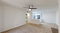 Located at 3720 W Alabama St in Houston's desirable 77027 corridor, this one-bedroom, one-bathroom unit offers a well-designed single-level layout. The open-concept kitchen and living area serves as the heart of the home, where the kitchen stands out with crisp white shaker cabinetry, white subway tile backsplash, light wood-look flooring, a skylight, and a full suite of stainless steel appliances including a range, microwave, dishwasher, and refrigerator. The living room flows seamlessly from the kitchen, featuring plush neutral carpeting, crown molding, a ceiling fan, and sliding glass doors that open onto a private balcony with outdoor views. The bedroom is a comfortable retreat with soft carpet, a ceiling fan, and a large window that brings in generous natural light. A dedicated closet provides convenient storage. The bathroom is finished in a clean, all-white palette with a soaking tub and shower combination, white tile surround, wood-look flooring, and overhead cabinetry for added storage. An in-unit washer and dryer area adds everyday practicality. The overall ambiance is bright, clean, and functional throughout.