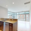 This contemporary 960 square foot apartment offers a thoughtful blend of style and functionality. The open-concept living area features bamboo flooring throughout, creating a seamless flow between spaces. Floor-to-ceiling windows in the main living area flood the space with natural light and provide stunning views of the surrounding cityscape.

The kitchen is a chef's delight, boasting sleek dark wood cabinetry, stainless steel appliances, and elegant granite countertops. A convenient breakfast bar separates the kitchen from the living area, perfect for casual dining or entertaining.

The apartment includes three bedrooms, with the primary bedroom measuring a spacious 160 square feet. All three bathrooms are well-appointed with modern fixtures, including dark wood vanities and large mirrors. Tile flooring in the bathrooms contrasts nicely with the bamboo flooring in the main living spaces.

A standout feature is the in-unit laundry, adding convenience to daily life. The apartment also includes a closet for additional storage. Recessed lighting throughout provides a clean, contemporary ambiance.

This efficiently designed space maximizes every square foot, offering a luxurious living experience in a compact urban footprint. Located at 777 S Broad, unit 238, this apartment combines modern amenities with a prime location, making it an ideal residence for those seeking a sophisticated city lifestyle.