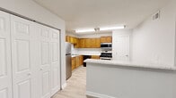 Located at 2665 Favor Rd SW in Marietta, Georgia, this single-story, 3-bedroom, 2-bathroom home offers a functional and well-organized layout across a comfortable footprint. The living room is a bright, open space featuring plush carpeting, a textured ceiling, and a sliding glass door fitted with vertical blinds that fills the room with natural light. Adjacent to the living area, the dining space connects seamlessly to the kitchen, which is a standout feature of the home. The kitchen is equipped with warm honey-toned wood cabinetry, stainless steel appliances including a gas range, over-the-range microwave, and refrigerator, as well as a black dishwasher. Light wood-style flooring and a peninsula with a marble-look countertop enhance both style and practicality. The three bedrooms are carpeted and bright, with windows offering views of surrounding greenery. The generously sized primary bedroom provides ample space for furnishings. Closets include wire shelving for organized storage. The bathrooms feature wood-style flooring, white cabinetry with marble-look countertops, and clean, neutral finishes throughout. Hallways connect the rooms efficiently, contributing to the home's practical, single-level flow.