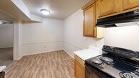 Located at 950 Military Rd in Jacksonville, Arkansas, this single-story home offers a practical and well-organized layout across three bedrooms and two full bathrooms. The galley-style kitchen is a functional highlight, featuring warm wood cabinetry, white countertops, a double stainless steel sink, and black appliances including a coil-burner range and refrigerator. Light wood-look flooring runs throughout the kitchen and dining area, adding a clean, cohesive feel. Each of the three bedrooms is carpeted and equipped with a ceiling fan with light kit, providing comfort year-round. The primary bedroom offers a comfortable footprint with closet access and connects conveniently to the rest of the home via a central hallway. One bedroom features a window with natural light and views of surrounding greenery, while others include closets for practical storage. Both bathrooms are finished with wood-toned vanity cabinetry, white countertops, mirrors, and combination tub-shower units. Wood-look flooring in the bathrooms complements the overall design. Textured ceilings are consistent throughout the home. The straightforward, single-floor layout with a connecting hallway makes this home easy to navigate and well-suited for a variety of living arrangements.