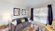 Located at 843 Scaleybark Rd in Charlotte, NC, this single-floor residence offers a well-organized layout with comfortable living spaces throughout. The living room is a welcoming area highlighted by large windows that allow generous natural light to fill the carpeted space, complemented by chair-rail molding that adds a classic architectural touch. Adjacent to the living room, the dining area continues the bright, airy feel with direct access to the outdoors through a full-light glass door, making it ideal for entertaining. A ceiling fan overhead adds both function and style to this space. The galley-style kitchen features white cabinetry, light countertops, wood-look flooring, and stainless steel appliances including a refrigerator, electric range, and dishwasher — offering an efficient and practical cooking environment. The bedroom is a serene retreat with plush carpeting, a window with stylish draping, and ample room for furnishings. The full bathroom is thoughtfully appointed with white cabinetry providing generous storage, a combined tub and shower, a toilet, and wood-look flooring that ties the space together cohesively. Neutral tones and consistent finishes throughout the home create a clean, move-in-ready atmosphere.