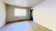 Located at 671 S Western Ave, Unit 207 in Neenah, WI, this second-floor apartment offers 630 square feet of living space across 3 bedrooms and 1 bathroom. Light wood-style luxury vinyl flooring runs consistently throughout the unit, providing a clean and cohesive look.

The primary bedroom spans 280 square feet and features a wall-mounted air conditioning unit, a large window with blinds for natural light, and baseboard heating. The additional two bedrooms are well-proportioned, each equipped with sliding dark-panel closet doors offering built-in storage, windows with blinds, and baseboard heating.

The kitchen is efficiently laid out with white cabinetry, light granite-style countertops, a double stainless steel sink, a range hood, and a white electric coil stove. The full bathroom includes a tub/shower combination with a white surround, a toilet, a vanity with storage, and baseboard heating.

Neutral, light-toned walls throughout the unit create a bright and open atmosphere. Baseboard heating is present in every room, ensuring consistent warmth. The unit's practical layout and clean finishes make it a functional and comfortable living space.