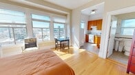 Located at 641 O'Farrell Street in San Francisco, this one-bedroom residence offers an efficient and well-organized layout across a single floor. The main living area is anchored by warm hardwood flooring and a set of large windows that frame sweeping city skyline views, filling the space with abundant natural light throughout the day. A small dining area near the windows provides a cozy spot to enjoy the urban scenery.

The bedroom is generously proportioned relative to the overall footprint, featuring the same hardwood flooring, a large window with city views, and a sliding mirrored closet that enhances the sense of space. Neutral wall tones throughout the unit contribute to a clean, airy ambiance.

The kitchen, accessible directly from the main room, is appointed with rich warm-toned wood cabinetry extending to the upper walls, a gas range, a sink with a window above, and light stone-look tile flooring — offering a fully functional cooking space in a compact layout.

The bathroom showcases classic white subway tile in the tub/shower surround, accented by decorative metallic mosaic border tiles that add a refined touch to the otherwise clean, simple design.

Overall, this residence combines practical city living with thoughtful details, making efficient use of its footprint in a prime San Francisco location.