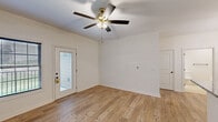 This efficiently designed single-story home in Richmond, Kentucky offers a thoughtfully laid-out floor plan that maximizes every square foot. The open-concept living room and kitchen area form the heart of the home, featuring warm light wood-tone flooring that flows seamlessly throughout. The living area is bright and airy, with a ceiling fan, a glass-panel exterior door, and a window that invite natural light into the space.

The kitchen is a standout, showcasing crisp white cabinetry with gold hardware, granite countertops, a decorative tile backsplash, and a full suite of stainless steel appliances. A peninsula with a granite countertop provides additional prep space and serves as a natural divider between the kitchen and living areas, accented by a stylish pendant chandelier above.

The spacious bedroom offers ample room and includes a ceiling fan, multiple windows for natural light, and a dedicated closet. The full bathroom features tile flooring, a tub-shower combination, and clean white finishes. A dedicated laundry area adds everyday convenience. Throughout the home, arched interior doors, white walls, and consistent flooring create a cohesive, modern aesthetic that is both functional and inviting.