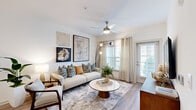 Located in Longs, South Carolina, this well-appointed 2-bedroom, 2-bathroom residence offers a thoughtfully designed single-floor layout that maximizes comfort and functionality. Wood-look plank flooring flows throughout, providing a cohesive and contemporary aesthetic.

The open-concept living, dining, and kitchen area forms the heart of the home. The living room features a ceiling fan, large windows with natural light, and direct access to an outdoor area via a glass door. The kitchen is equipped with stainless steel appliances, gray shaker-style cabinetry, a white quartz countertop, and a peninsula breakfast bar illuminated by pendant lighting — ideal for casual dining. A separate dining nook with built-in shelving provides additional space for entertaining.

The spacious primary bedroom features a ceiling fan, broad windows with outdoor views, and a calming neutral palette. A walk-in closet with wire shelving and ample hanging space adds to its practicality. The second bedroom is equally bright and well-proportioned. Both bathrooms are clean and modern, with one featuring a tiled tub-shower combination, quartz vanity countertop, and wood-look flooring. The layout also includes a hallway connecting all rooms efficiently, contributing to a smooth and functional flow throughout the residence.