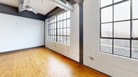 This 850 sq ft loft-style apartment combines modern amenities with industrial character. The open floor plan showcases high ceilings with exposed ductwork and large windows that flood the space with natural light. The kitchen boasts dark wood cabinetry, granite countertops, and stainless steel appliances. The living area features hardwood floors and ample space for both living and dining. The bedroom, measuring 130 sq ft, offers privacy and two spacious closets. Two well-appointed bathrooms, one with a tub-shower combination, complete this urban retreat. Located in downtown Winston-Salem, this unit offers a perfect blend of city living and home comfort.