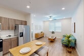 Located at 12121 Greenspoint Drive in Houston, TX, this single-story, 3-bedroom, 2-bathroom home offers a clean, modern design with consistent light wood-tone flooring and a neutral color palette throughout. The open-concept living and dining area flows seamlessly from the kitchen, creating an inviting communal space anchored by recessed lighting and a ceiling fan. Natural light filters in through blinds-fitted windows, enhancing the bright, airy ambiance.

The kitchen is well-equipped with rich walnut-toned cabinetry, granite countertops, a white subway tile backsplash, and a full suite of stainless steel appliances including a refrigerator, range, microwave, and dishwasher. A kitchen island provides additional prep and dining space.

The primary bedroom offers a comfortable retreat with its own ceiling fan and an adjacent closet. The two additional bedrooms are versatile, well-lit spaces with ceiling fans and windows, suitable as guest rooms or a home office. Each bathroom features wood-look flooring and clean, functional fixtures. The home also includes a dedicated laundry area, utility room, hallway, and three closets, ensuring ample storage and practical everyday functionality.