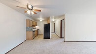 Located at 5900 West Lucerne Court in Mequon, Wisconsin, this 2-bedroom, 2-bathroom residence offers a practical and well-organized single-floor layout. The open kitchen and living area serves as the heart of the home, featuring warm wood cabinetry, a mosaic tile backsplash, stone-look countertops, and stainless steel appliances including a dishwasher and gas range. A ceiling fan overhead and soft carpeting in the living area contribute to a comfortable atmosphere throughout.

Both bedrooms are carpeted and finished with clean white walls, baseboard heating, and wood-trimmed accents. The primary bedroom is a well-proportioned retreat with a large double-door closet providing ample storage. A second bedroom also benefits from natural light through a window with a view of the surrounding greenery.

The two bathrooms are finished with tile flooring, wood vanities with stone-look countertops, and mirrored medicine cabinets. One bathroom includes a full tub/shower combination. A wall-mounted air conditioning unit is also present in the unit.

A standout feature of this residence is the private balcony, which overlooks a lush, tree-lined green space — offering a peaceful outdoor retreat with scenic views of the well-maintained grounds surrounding the property.