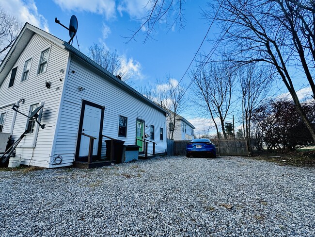 Front door and 4 full sized vehicle parking lot - 128 Main St