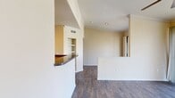 This 720 square foot apartment in Cedar Park, TX offers a thoughtful layout maximizing space and functionality. The open-concept design seamlessly integrates the kitchen, dining, and living areas, creating an airy atmosphere. The kitchen boasts modern stainless steel appliances, dark wood cabinetry, and a granite-topped breakfast bar, ideal for casual dining or entertaining.

The living room features wood-look flooring and a ceiling fan, with access to a private balcony offering outdoor views. Built-in shelving adds character and storage to the space. The bedroom is generously sized at 180 square feet, with plush carpeting and a ceiling fan for comfort. It includes a walk-in closet for ample storage.

The bathroom showcases a modern vanity with a granite countertop, large mirror, and a shower/tub combination. Additional amenities include a separate utility room for laundry, and a second closet for extra storage. Throughout the apartment, neutral tones create a bright and inviting ambiance, allowing for personalization. The property's location at 2201 S Lakeline Blvd provides convenient access to local amenities in the Cedar Park area.