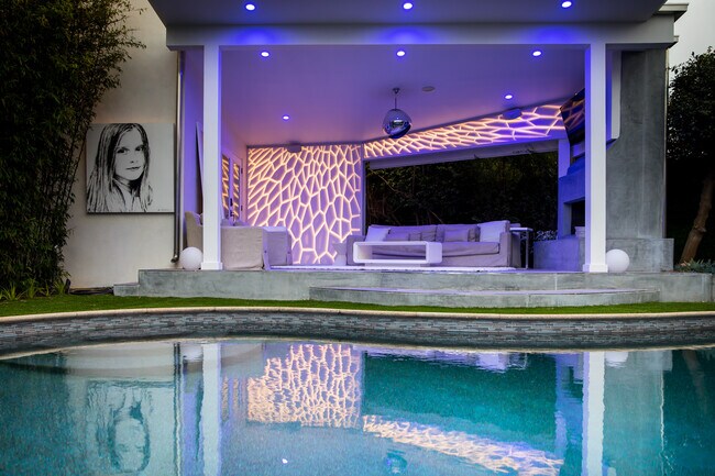 Night view of outdoor living room in backyard - 6952 W 77th St