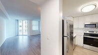 Located at 255 Evervia St in West Palm Beach, FL, this well-appointed residence offers three bedrooms and four bathrooms across a single floor. The interior is unified by light wood-tone flooring that extends throughout, complemented by crisp white walls and textured ceilings that create a clean, contemporary aesthetic.

The kitchen is outfitted with stainless steel appliances—including a refrigerator, range, and over-the-range microwave—set against white cabinetry and light countertops, giving the space a modern, functional character. The adjoining living area is open and airy, featuring large windows and sliding glass doors that invite natural light and offer outdoor views.

Each bedroom is generously proportioned with windows fitted with vertical blinds for light control. The primary bedroom provides a comfortable retreat with dedicated space for rest and relaxation. The bedrooms connect through a central hallway that facilitates smooth circulation throughout the unit.

The four bathrooms are finished in a consistent, clean style. Several feature tub-shower combinations with white tile surrounds, while others include vanities with white cabinetry, framed mirrors, and elegant multi-bulb light fixtures above—all set on wood-look flooring for a cohesive look. The overall ambiance is bright, neutral, and move-in ready.