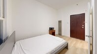 Located at 710 S Broadway in the heart of Downtown Los Angeles, this compact studio unit offers a practical and efficiently designed layout across a single floor. The space is finished with light wood laminate flooring throughout, crisp white walls, and a textured ceiling, creating a clean and bright interior aesthetic.

The main living area serves as the primary room, accommodating a bed, a small side table, and a slim vertical heater unit. A compact kitchenette is tucked into one corner, equipped with a miniature refrigerator and a small cooktop, making efficient use of the available space. A window allows natural light to enter the room, adding openness to the otherwise compact footprint.

A dedicated closet provides essential storage, accessible directly from the main room. The bathroom is cleanly finished in all white, featuring a pedestal sink with brushed nickel fixtures and a walk-in shower with a curtain enclosure, alongside a toilet. The space is utilitarian yet complete.

Entry is through a solid wood door, and the overall layout is straightforward and easy to navigate. This studio is well-suited for individuals seeking a self-contained living space in a prime Downtown Los Angeles location, close to transit, dining, and the city's urban core.
