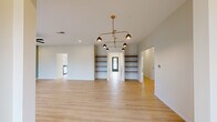 Located at 678 Edinburgh Way in Seneca, SC, this two-story property offers an expansive layout spread across two generously sized floors, providing ample space for large households or multi-occupant living. Light hardwood-style flooring runs consistently throughout the home, creating a cohesive and clean aesthetic across all rooms.

The main floor features a combined dining room and kitchen equipped with stainless steel appliances, including a large side-by-side refrigerator, range, microwave, and dishwasher. White cabinetry, pendant lighting, and a wide sliding glass door that floods the space with natural light define the kitchen's modern character. Two living rooms provide flexible communal areas, each featuring distinctive built-in open shelving and stylish gold-toned multi-arm pendant light fixtures.

The property's eleven bedrooms are distributed across both floors, connected by six hallways and two staircases. Bedrooms feature mirrored sliding-door closets with built-in shelving and large windows offering outdoor views. The primary bedroom provides a generous footprint with recessed lighting.

Seven bathrooms are finished in a contemporary style, featuring wood-toned vanities, large mirrors, glass-enclosed walk-in showers with white tile surrounds, and soft sage-toned walls. Two closets and a welcoming entrance complete this well-appointed property.