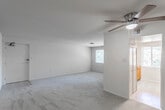 This single-story unit offers a practical, well-organized layout designed for comfortable everyday living. The spacious living area is finished with neutral-toned carpet and features a ceiling fan with a built-in light fixture, providing both air circulation and ambient lighting. A generously sized window allows natural light to fill the room while offering views of surrounding greenery. The living space flows conveniently toward the kitchen, which is designed in a galley configuration. It features warm wood-toned cabinetry, granite-look countertops on both sides, a stainless steel sink, and white appliances including a refrigerator and dishwasher, all set on easy-to-maintain tile flooring.

The bedrooms are carpeted and maintain the neutral color palette found throughout the unit. Each room is equipped with a ceiling fan and light, and at least one bedroom features a built-in closet with shelving for organized storage. The bedroom windows provide natural light and views of mature trees outside.

The bathroom is finished with classic white subway tile, a vanity with a light wood cabinet base, white countertop, and a mirror. The overall ambiance of the unit is clean, functional, and move-in ready, with a consistent neutral palette that offers a versatile backdrop for any furnishing style.
