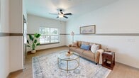 Located at 2401 6th St in Lake Charles, Louisiana, this single-floor, 2-bedroom, 1-bathroom residence offers a clean, modern aesthetic throughout. Light wood-look flooring runs continuously across the main living areas, complemented by crisp white walls accented with a distinctive gray horizontal band — a consistent design detail that unifies each room.

The open-concept kitchen and living area forms the heart of the home. The kitchen is outfitted with gray shaker-style cabinetry, granite countertops, black appliances, and a peninsula island with bar seating — ideal for casual dining. A pantry provides additional storage convenience. The living room benefits from natural light through a large window, a ceiling fan, and comfortable proportions that make it a welcoming gathering space.

Both bedrooms continue the cohesive design language, featuring the same light flooring and accent wall detail. The primary bedroom includes a ceiling fan and window with outdoor views. A full bathroom offers marble-style tile flooring, a granite-topped vanity with gray cabinetry, and a walk-in style shower/bath area. Four closets throughout the unit provide ample storage. Additional features include an in-unit laundry area and an outdoor patio, extending the living space beyond the interior.
