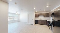 Located at 1202 Main St in Lubbock, TX, this single-story, 3-bedroom, 2-bathroom home delivers a clean and modern living experience with thoughtfully selected finishes throughout. The open-concept kitchen and living area serves as the heart of the home, featuring light marble-style tile flooring, recessed lighting, and a large bank of windows fitted with horizontal blinds that invite natural light and outdoor views. The kitchen is well-equipped with dark wood cabinetry, light stone countertops, and black appliances including a refrigerator, range, microwave, and dishwasher. The three bedrooms are carpeted in a neutral blue-grey tone, offering a comfortable and quiet retreat. Each room features white walls, ceiling fans with integrated lighting, and windows overlooking the outdoors. The spacious primary bedroom provides a generous personal space. The two bathrooms are finished with marble-style tile flooring and white fixtures; one includes a walk-in shower with grab bars, while the other features a full soaking tub with a shower rod. Clean white walls, modern hardware, and a vanity with dark cabinetry complete the bathrooms. A connecting hallway ties the layout together efficiently, making this home functional and move-in ready.