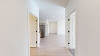 Located at 1060 Crest Way in York, PA, this well-appointed single-floor home offers three bedrooms, two full bathrooms, and a thoughtfully designed layout. Light-toned hardwood-style flooring flows through the main living areas, creating a bright and cohesive aesthetic throughout. The kitchen is a standout feature, showcasing gray shaker-style cabinetry, stainless steel appliances including a refrigerator, range, microwave, and dishwasher, along with light countertops and a functional U-shaped layout that maximizes workspace. The kitchen opens toward the living room, creating an easy flow for daily living and entertaining. The primary bedroom is generously sized, featuring natural light from a window with blinds and louvered closet doors for convenient storage. The two additional bedrooms are carpeted and naturally lit, each offering a comfortable and quiet retreat. Both bathrooms are finished with gray vanities, white countertops, lighted mirrors, and tub-shower combinations set over light wood-look flooring. A dedicated laundry room houses a full-size washer and dryer with overhead shelving for added convenience. Clean white walls, recessed lighting, and a consistent modern finish give the entire home a fresh, move-in-ready feel.