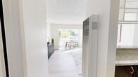Located at 2429 Aberdeen Way in Richmond, CA, this efficiently designed single-floor, one-bedroom, one-bathroom home makes excellent use of its cozy footprint. The open-concept living and dining area is the heart of the space, bathed in natural light streaming through a large picture window that frames pleasant outdoor views. Light wood-tone flooring runs throughout, complementing the crisp white walls and textured ceilings to create a clean, airy aesthetic. The living area offers generous room for both a seating arrangement and a dedicated dining space, making it well-suited for both relaxing and entertaining. A side entry corridor leads past a built-in wall unit, adding a practical and stylish touch to the layout. The bedroom is a comfortable retreat, featuring a sizable sliding-door closet for ample storage, a window overlooking lush greenery, and direct access to the bathroom. The bathroom is finished with a granite-topped vanity, a tub-shower combination, and warm wood-look flooring that ties the space together. A separate closet off the bathroom provides additional storage. Throughout the home, the consistent use of neutral tones, natural light, and clean lines creates a calm, cohesive atmosphere ideal for everyday living.