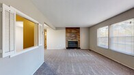 Located on Detroit Road in Rocky River, Ohio, this two-bedroom, two-bathroom residence offers a practical and comfortable single-floor layout. The living room serves as the focal point of the home, featuring a full-height brick fireplace that adds character and warmth to the space. Plush carpeting, neutral gray walls, and multiple windows with blinds allow natural light to fill the room, creating a welcoming atmosphere. A front entry area with tile flooring transitions seamlessly into the carpeted living space.

The kitchen is equipped with white cabinetry, wood-toned countertops, a stainless steel sink, a dishwasher, and a refrigerator, all set atop wood-look vinyl flooring — providing a clean and functional workspace.

Both bedrooms are carpeted and finished in neutral tones, each featuring windows that bring in natural light. The spacious primary bedroom offers ample room for furnishings, while the second bedroom provides a cozy and versatile space.

The two bathrooms are finished with tile flooring and white fixtures. One bathroom includes a walk-in shower with white subway tile surround, while the second features a full soaking tub with a tiled surround — accommodating a range of preferences. A hallway connects the home's rooms, completing this well-organized layout.