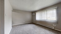 Located at 2704 Westmar Ct in Toledo, Ohio, this one-bedroom, one-bathroom unit offers a practical and well-organized floor plan across a single level. Neutral gray tones and white trim carry throughout, creating a clean, cohesive aesthetic.

The living room is generously sized for the overall footprint, featuring wall-to-wall carpet, a large window with vertical blinds that invites ample natural light, a wall-mounted air conditioning unit, and a baseboard heating system. The space is bright and open, offering a comfortable area for relaxing or entertaining.

The kitchen is efficiently laid out with dark espresso cabinetry, light countertops, a stainless steel sink, an electric range, and a refrigerator. Wood-look vinyl plank flooring runs underfoot, adding a modern touch and easy maintenance.

The bedroom is a well-proportioned private retreat, also finished with carpet and neutral walls. It includes a large double-door closet with louvered panels and a window providing natural light. Two additional closets elsewhere in the unit offer excellent storage capacity — a notable feature for a space of this size.

The bathroom includes a full tub/shower combo, a vanity with storage, and wood-look vinyl plank flooring that ties in with the kitchen. Baseboard heating is present throughout the unit, ensuring year-round comfort.