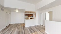 Located at 1268 W Clark Rd in DeWitt, Michigan, this three-bedroom, two-bathroom single-floor unit offers a practical and well-appointed layout. The open-concept living and kitchen area forms the heart of the home, where wood-look laminate flooring flows throughout. The kitchen is defined by rich dark-toned cabinetry, stainless steel appliances including a gas range and refrigerator, a light-colored peninsula countertop with an integrated sink, and track lighting overhead. Conveniently tucked just off the kitchen is an in-unit laundry area with side-by-side washer and dryer hookups. The living space benefits from clean white walls and an open, airy feel. The three bedrooms are carpeted for comfort, with each room offering ample natural light through standard windows with blinds. The primary bedroom includes dual closets, providing generous storage. Both bathrooms feature wood-look flooring, a tub-shower combination, a white vanity countertop, and dark wood cabinetry beneath. The overall aesthetic throughout the unit is clean and neutral, with a consistent light color palette that creates a bright and welcoming atmosphere across all spaces.