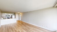 Located at 7600 Stenton Ave in Philadelphia's 19118 zip code, this one-bedroom, one-bathroom unit offers a well-organized, single-floor layout designed for comfortable everyday living. Light wood-tone flooring runs throughout the space, lending a clean and cohesive look to every room.

The open-concept kitchen and living area forms the heart of the unit. The kitchen features white cabinetry, stainless steel appliances including a refrigerator, microwave, and range, and a peninsula with a light quartz countertop that doubles as a breakfast bar. The living area is generously sized with neutral gray walls and large windows fitted with vertical blinds, allowing ample natural light to fill the space.

The bedroom is a comfortable, well-proportioned room with large windows that bring in natural light and offer outdoor views. It includes access to a closet and connects easily to the hallway. In total, the unit provides three closets, offering excellent storage throughout.

The bathroom is neatly appointed with a white vanity, mirrored medicine cabinet, and tiled half-walls, maintaining the unit's clean, modern aesthetic. A private balcony, accessible from the living area, extends the living space outdoors. A hallway connects the main rooms, completing this thoughtfully laid-out unit.