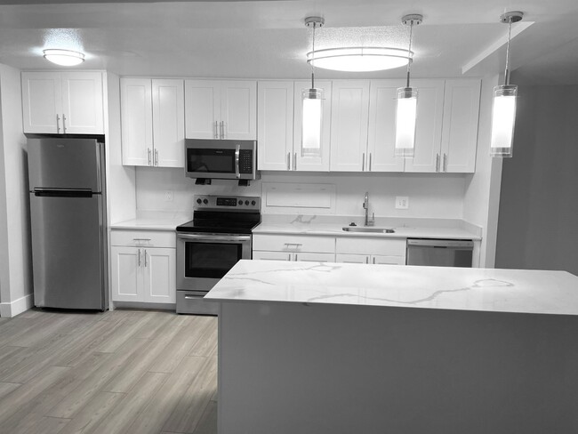 Modern White Kitchen With A Quartz Countertop - Towers at Wyncote